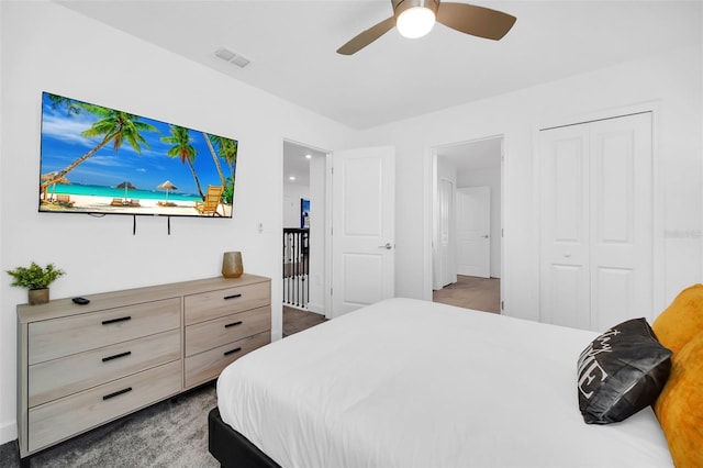 bedroom featuring dark colored carpet, a closet, and ceiling fan