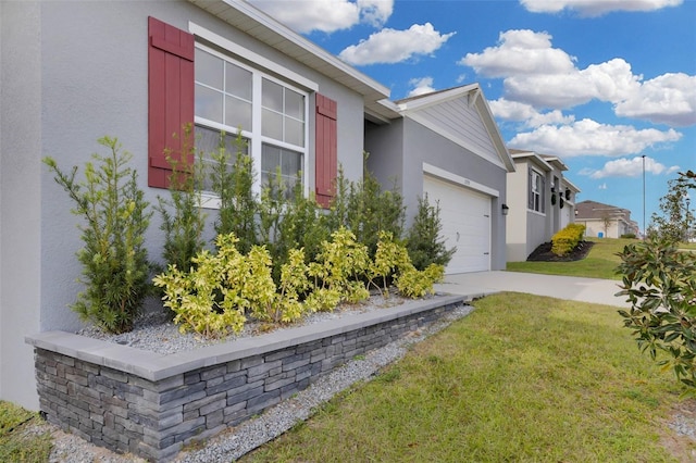 view of property exterior featuring a lawn and a garage