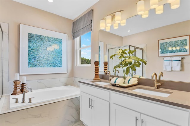 bathroom with vanity and independent shower and bath