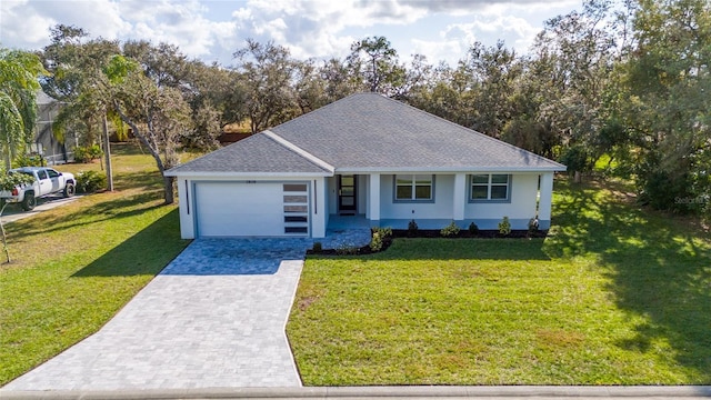 view of front of property featuring a garage and a front yard