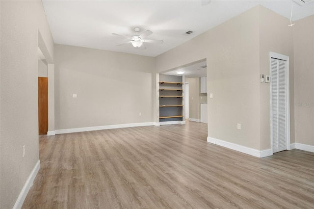 unfurnished living room with ceiling fan and light wood-type flooring