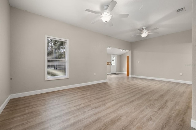 unfurnished room with light hardwood / wood-style floors, a wealth of natural light, and ceiling fan