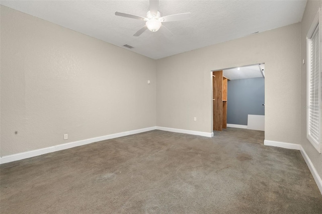 carpeted empty room featuring ceiling fan