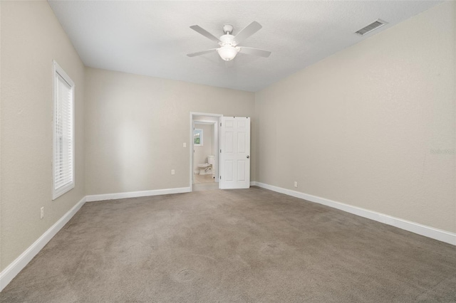 unfurnished room with carpet flooring and ceiling fan