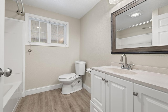 full bathroom with vanity, wood-type flooring, bathtub / shower combination, and toilet