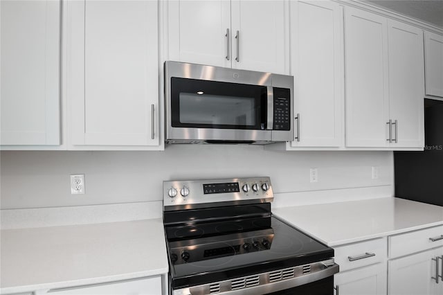 kitchen with stainless steel appliances and white cabinetry