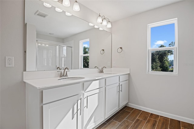 bathroom with vanity and a shower with shower door