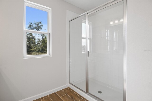 bathroom with a shower with door