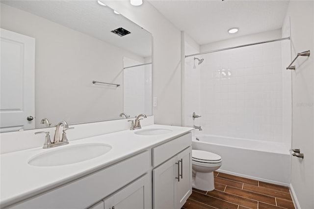 full bathroom featuring vanity, bathing tub / shower combination, and toilet