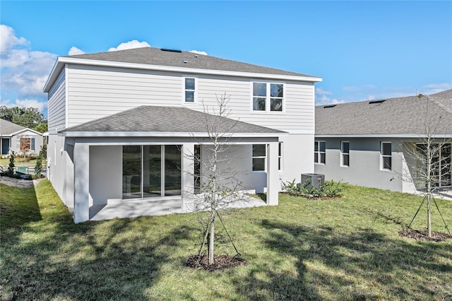 back of property with a lawn, a patio area, and central AC unit