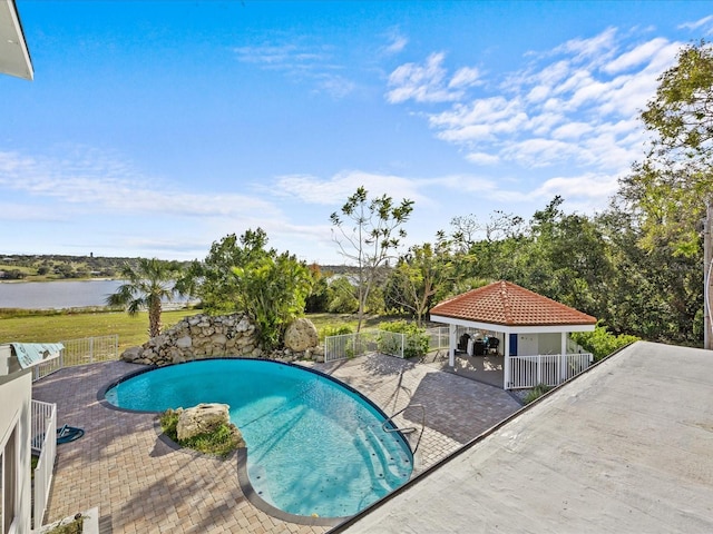 view of swimming pool featuring a gazebo, a patio area, and a water view