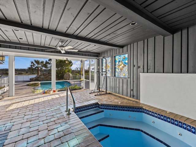 view of swimming pool with ceiling fan, a patio, and an indoor in ground hot tub