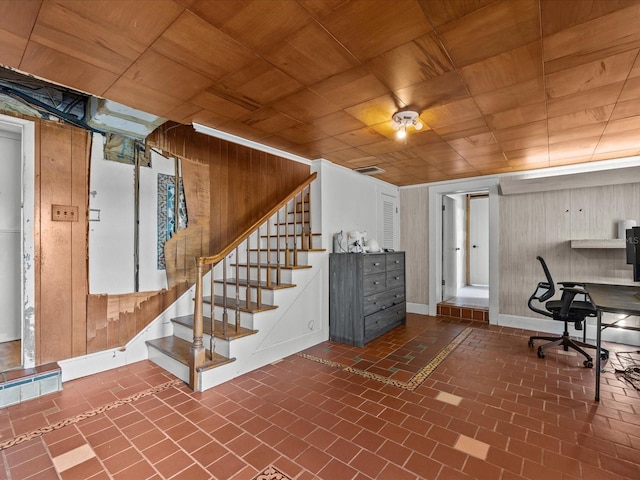 unfurnished office featuring wooden walls and wood ceiling