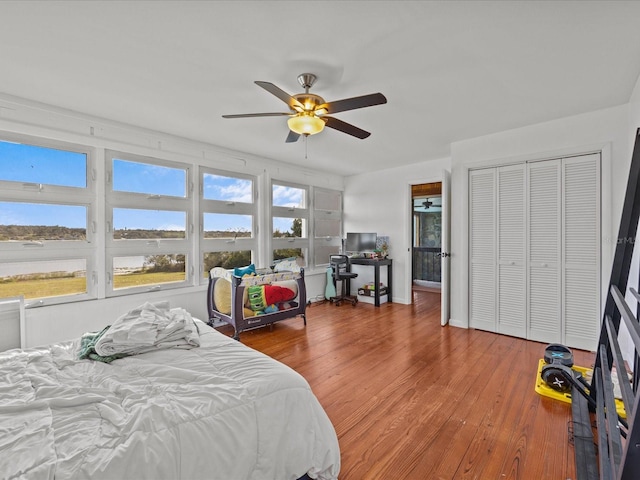 bedroom featuring wood-type flooring, a closet, and ceiling fan