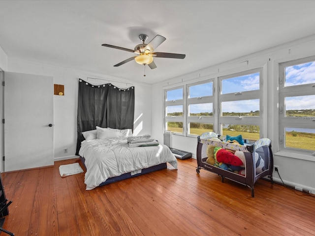 bedroom featuring hardwood / wood-style flooring and ceiling fan