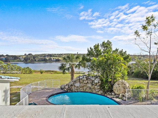 view of swimming pool with a water view