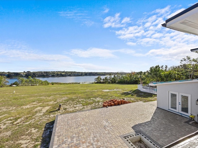 view of patio featuring a water view and french doors