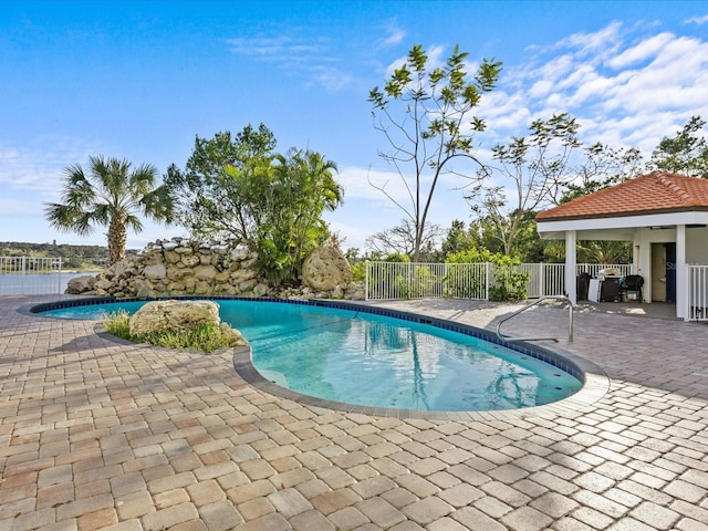 view of swimming pool featuring a patio area