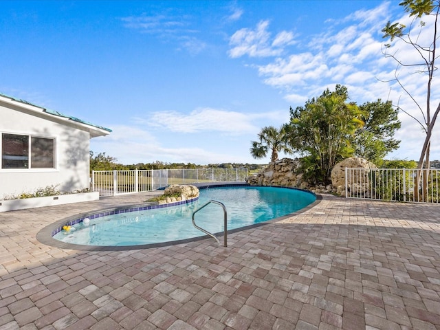 view of swimming pool with a patio