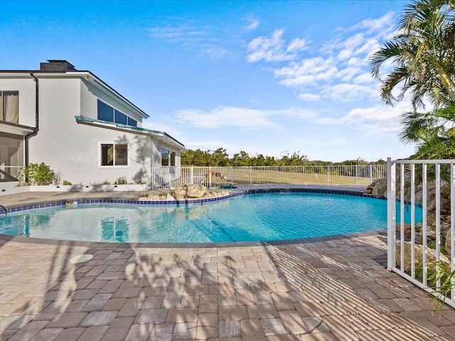 view of swimming pool with a patio