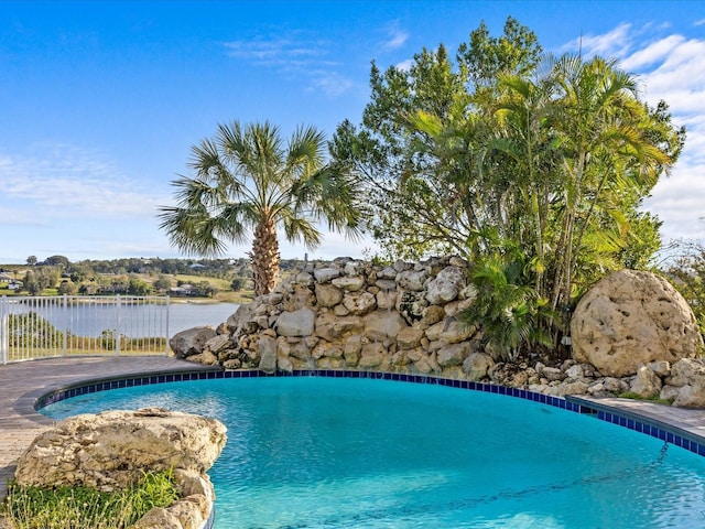 view of swimming pool featuring a water view