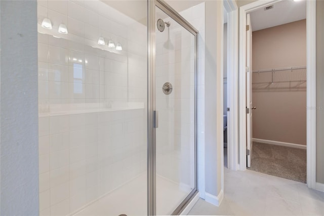 bathroom with tile patterned flooring and a shower with shower door