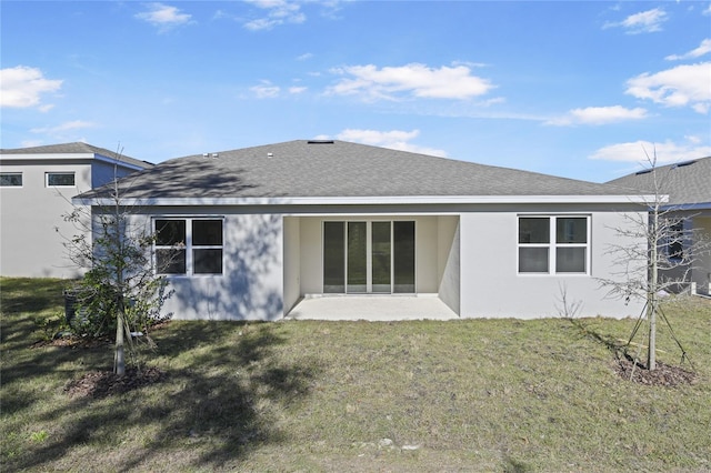 rear view of house featuring a lawn and a patio area