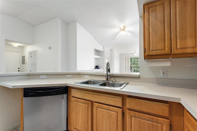 kitchen featuring ceiling fan, sink, stainless steel dishwasher, kitchen peninsula, and lofted ceiling