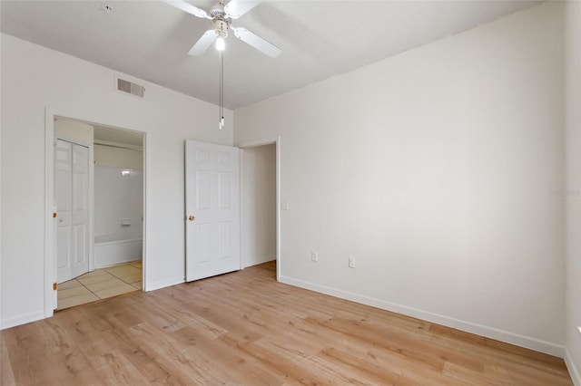 unfurnished bedroom with ceiling fan and light wood-type flooring