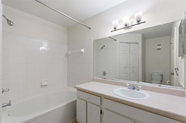 full bathroom featuring shower / bathing tub combination, vanity, and toilet