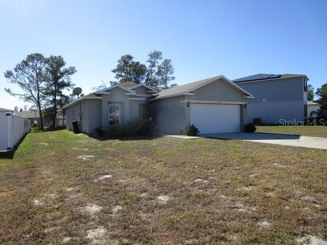 single story home with a garage and a front lawn