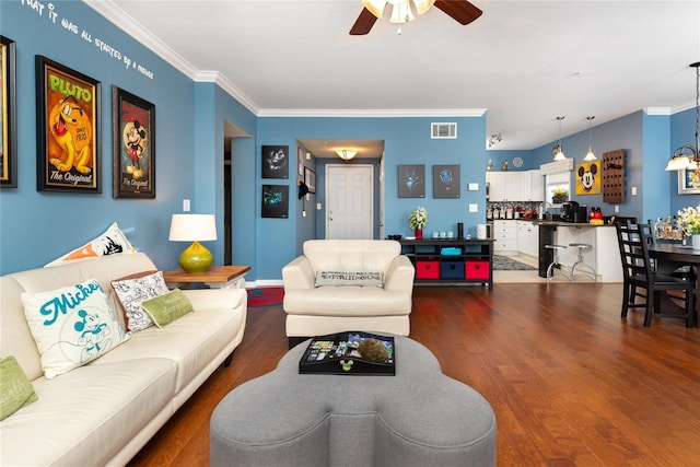 living room with ceiling fan, dark hardwood / wood-style flooring, and crown molding