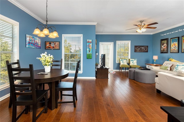 dining space with ceiling fan with notable chandelier, dark hardwood / wood-style floors, and ornamental molding