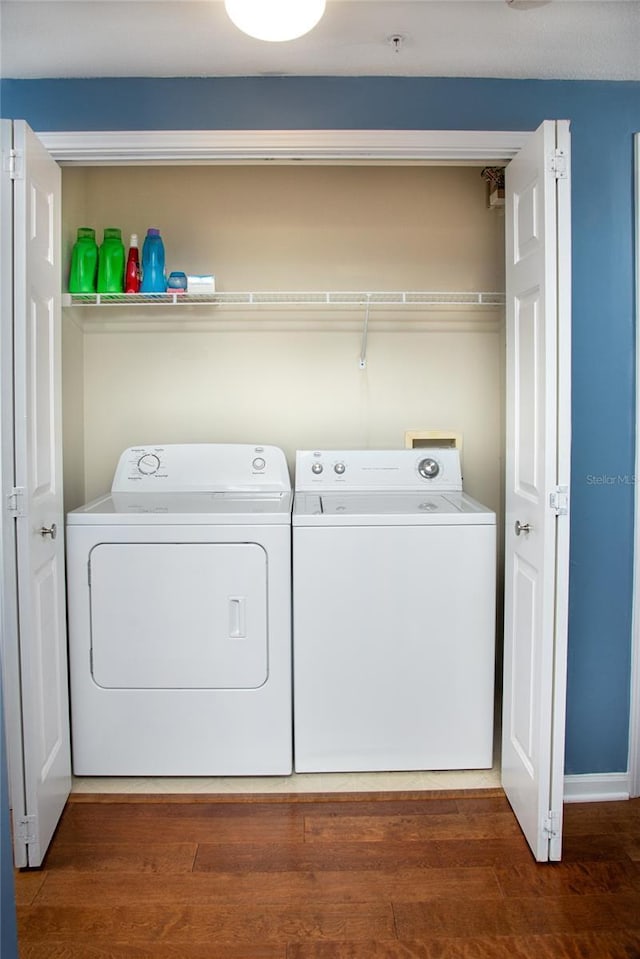 laundry room featuring washer and clothes dryer and dark wood-type flooring