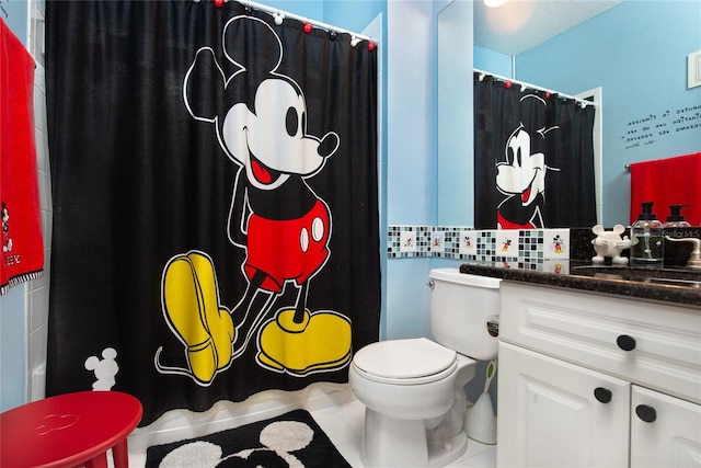 bathroom with tile patterned floors, vanity, and toilet