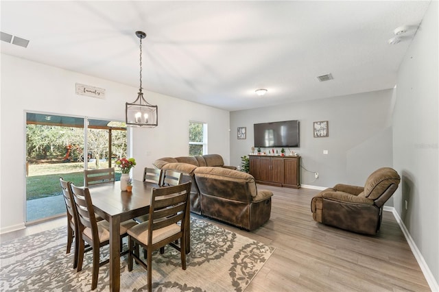 dining room with an inviting chandelier and light wood-type flooring