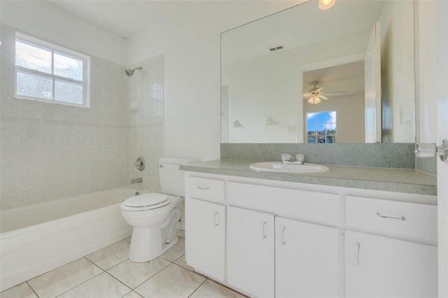 full bathroom with ceiling fan, tile patterned floors, toilet, vanity, and tiled shower / bath