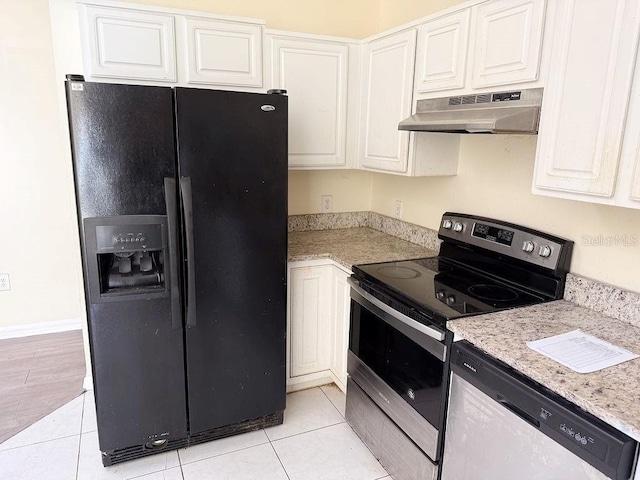 kitchen with white cabinetry, appliances with stainless steel finishes, light tile patterned floors, and light stone counters