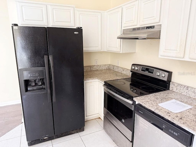 kitchen featuring white cabinetry, stainless steel appliances, light stone counters, and light tile patterned floors