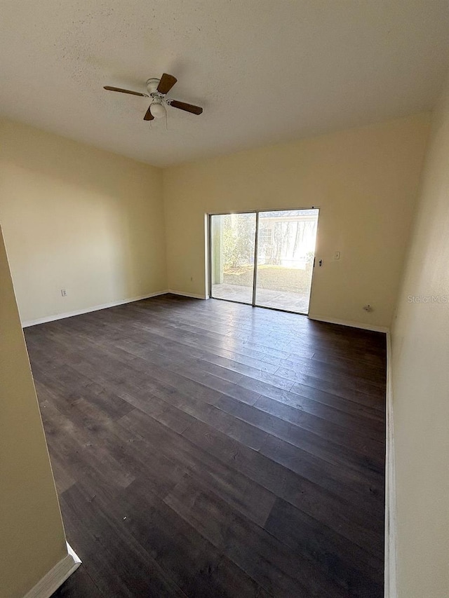 unfurnished room featuring dark wood-type flooring, ceiling fan, and a textured ceiling