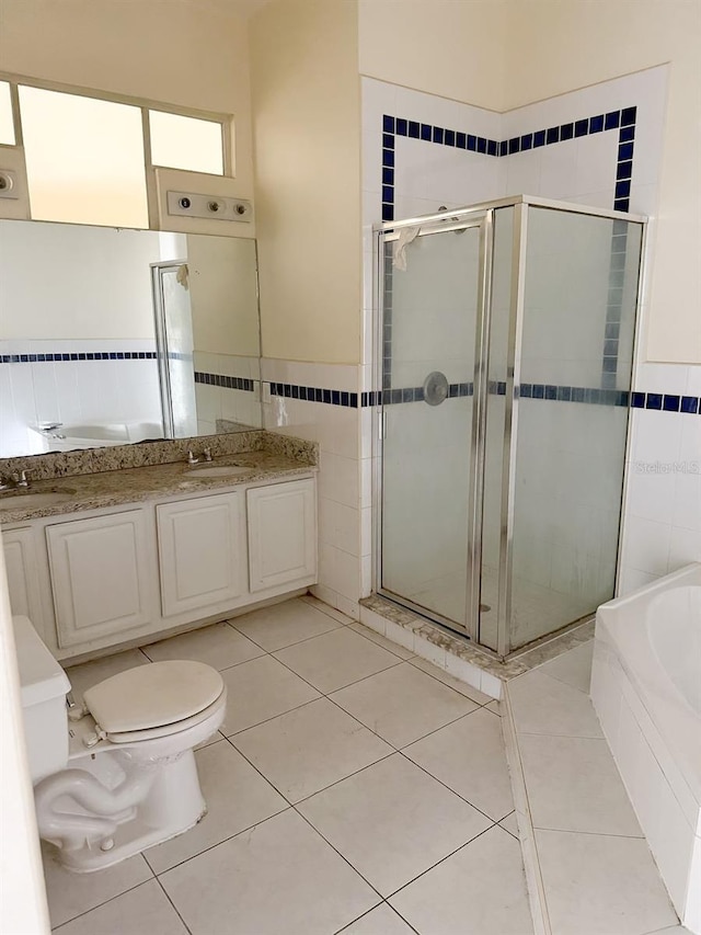 full bathroom featuring tile patterned floors, vanity, separate shower and tub, and tile walls