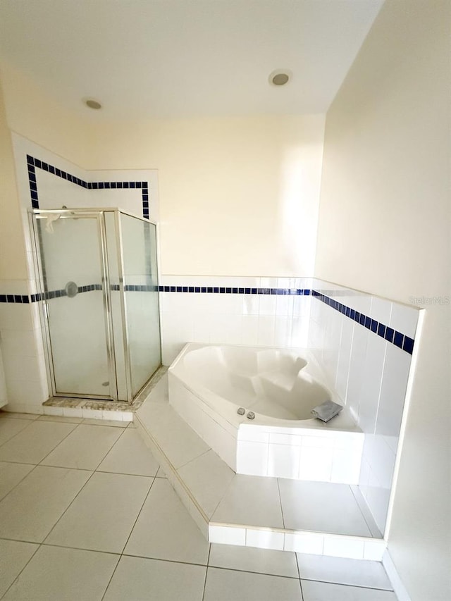 bathroom featuring tile patterned flooring and independent shower and bath