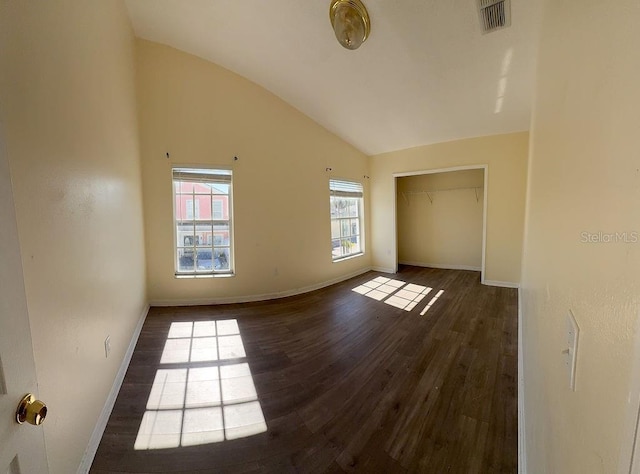 empty room featuring dark hardwood / wood-style floors and high vaulted ceiling