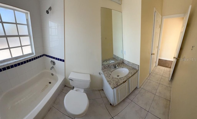 full bathroom with vanity, tiled shower / bath, tile patterned floors, and toilet