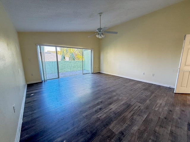 interior space with vaulted ceiling, dark wood-type flooring, a textured ceiling, and ceiling fan