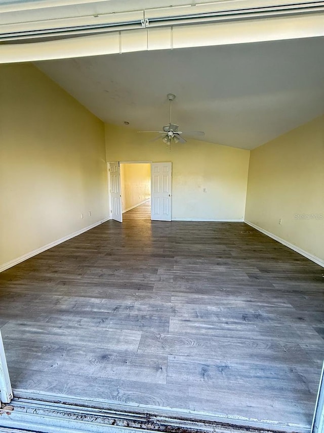 interior space with ceiling fan, lofted ceiling, and dark hardwood / wood-style flooring