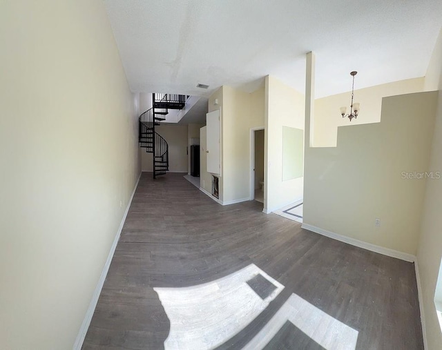 hall featuring hardwood / wood-style flooring and an inviting chandelier