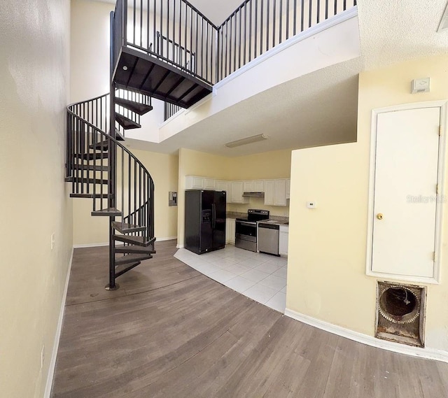 entrance foyer featuring a high ceiling and light hardwood / wood-style floors