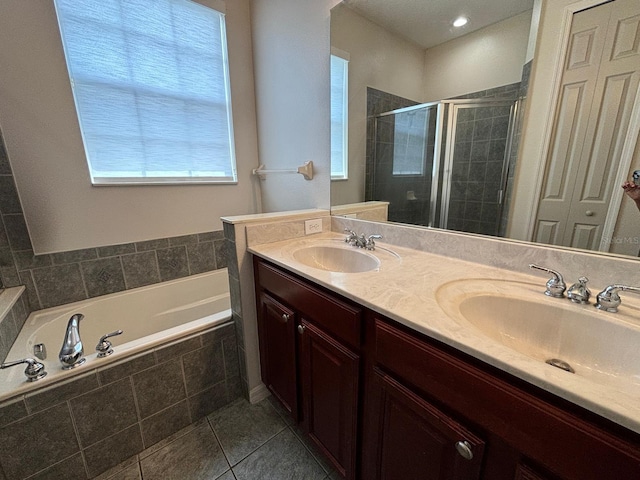 bathroom featuring tile patterned flooring, shower with separate bathtub, and vanity