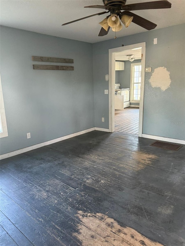 unfurnished room with ceiling fan and dark wood-type flooring